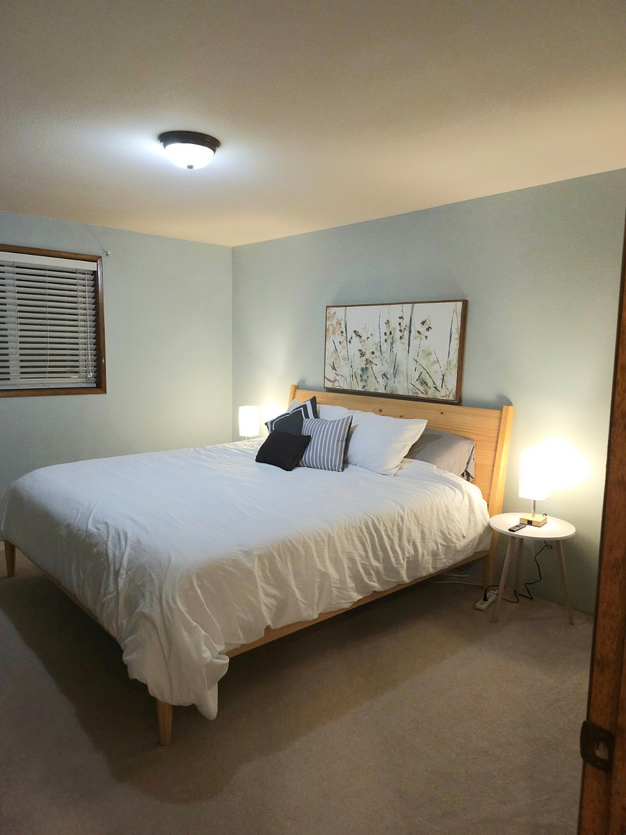 Bedroom 1 has a king size bed, walk in closet, dresser, and smart TV.
