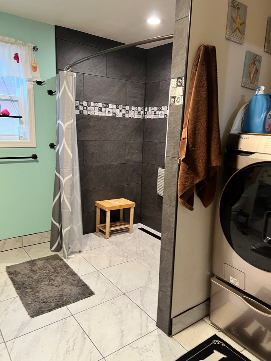 Large walk-in shower with rain shower and handheld sprayer