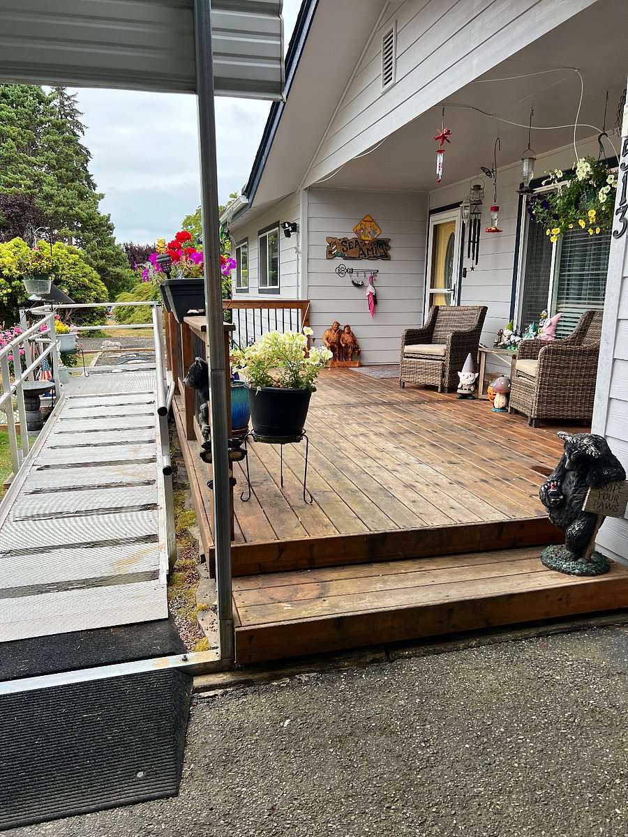 Front deck includes wheelchair ramp and outdoor seating area. Yellow door is the main front door. Private entrance into rental space is to the left. 
Rental space is wheelchair friendly with large doorways and hall. 