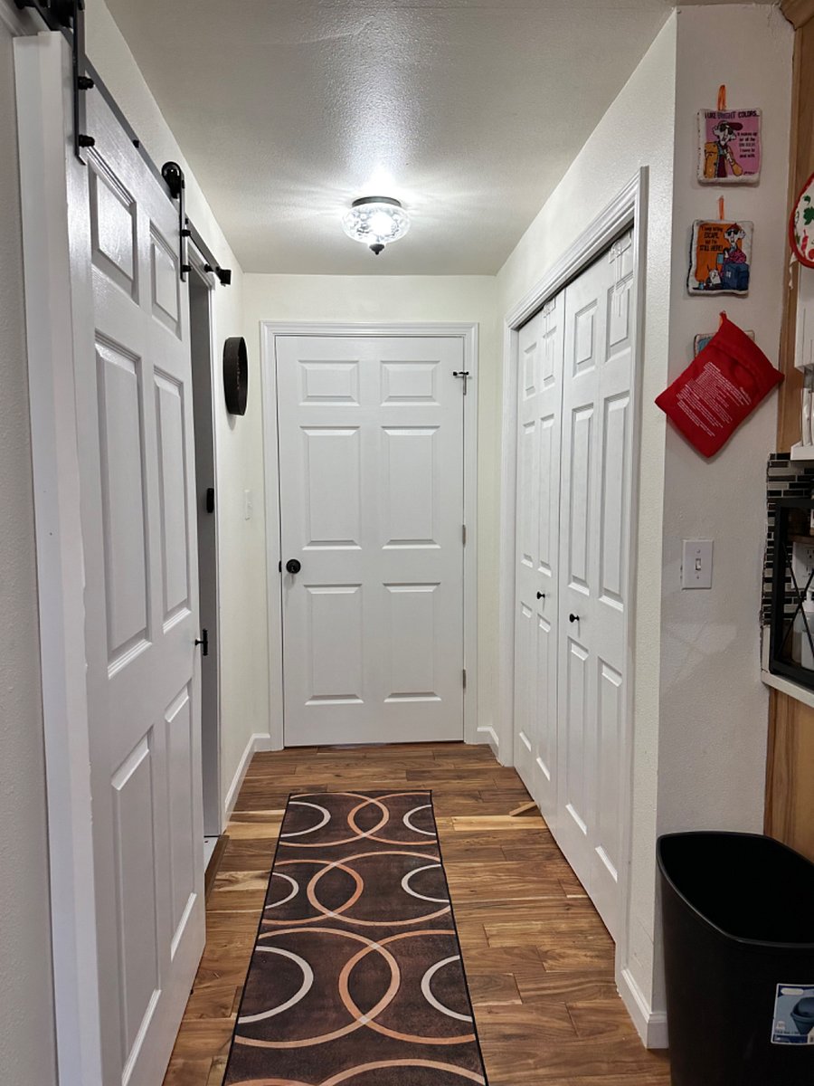 Private bathroom to the left, bedroom door straight ahead, closet to the right