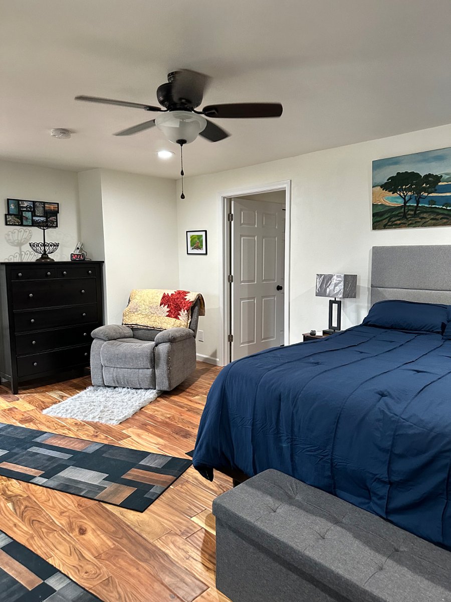 View from small table towards bedroom door into hallway and shared space. 