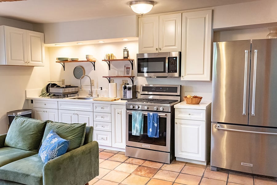 Full kitchen with oven, stove top, microwave, refrigerator, and Nespresso.