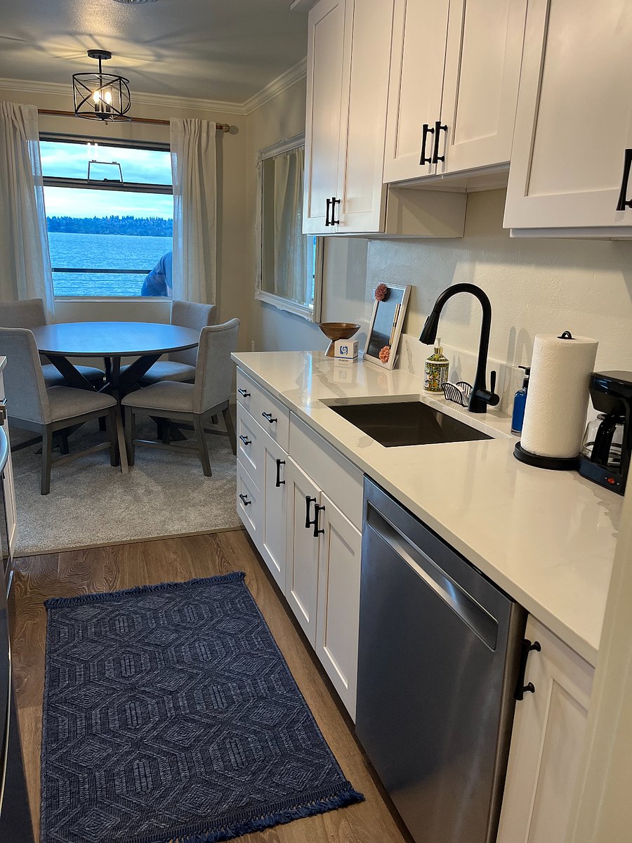 Galley kitchen and dining room with lake views.

