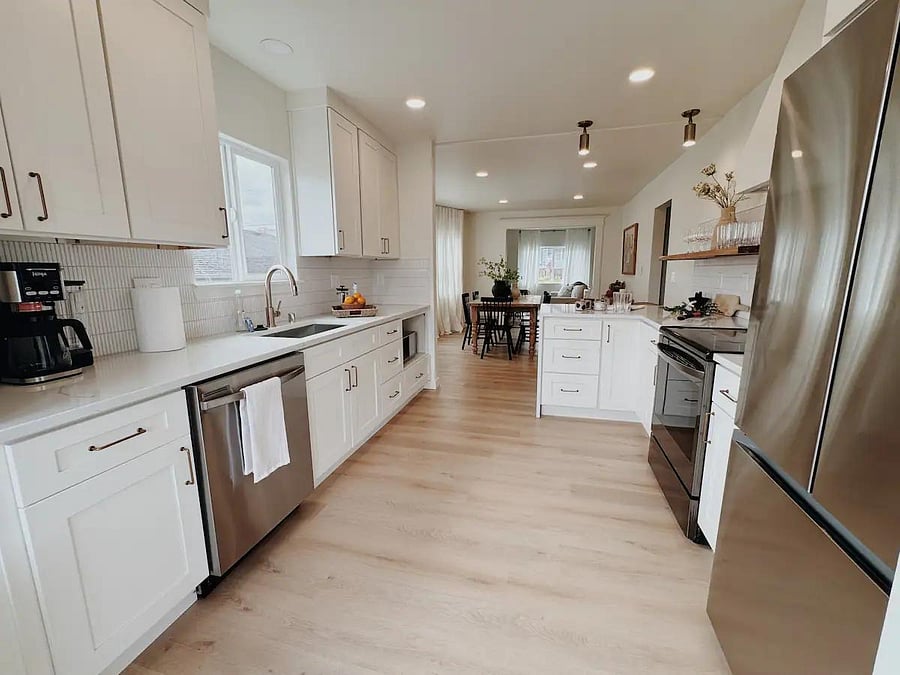 Fully equipped kitchen with cookware, utensils, and coffee maker.