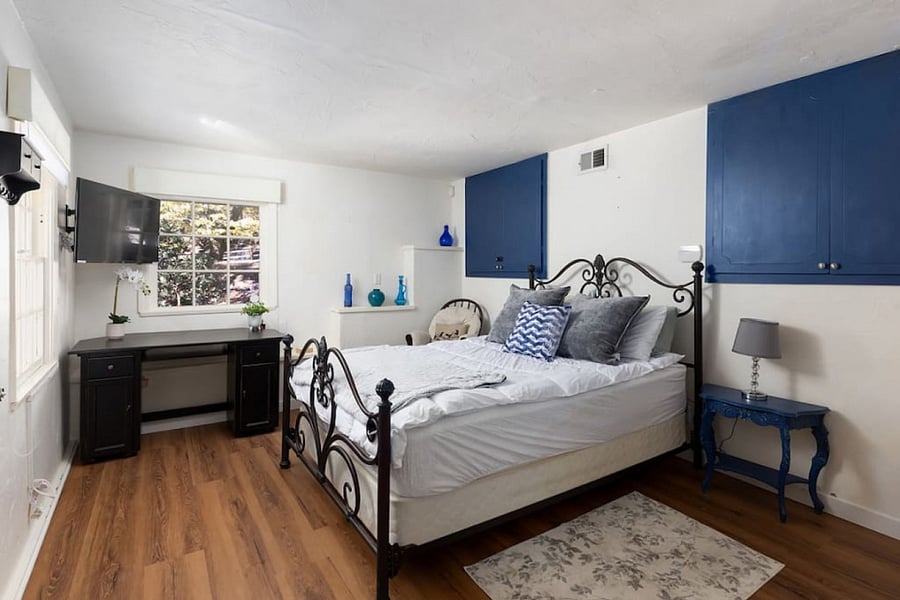 Spacious light airy room with queen bed, desk, TV and plenty of storage.