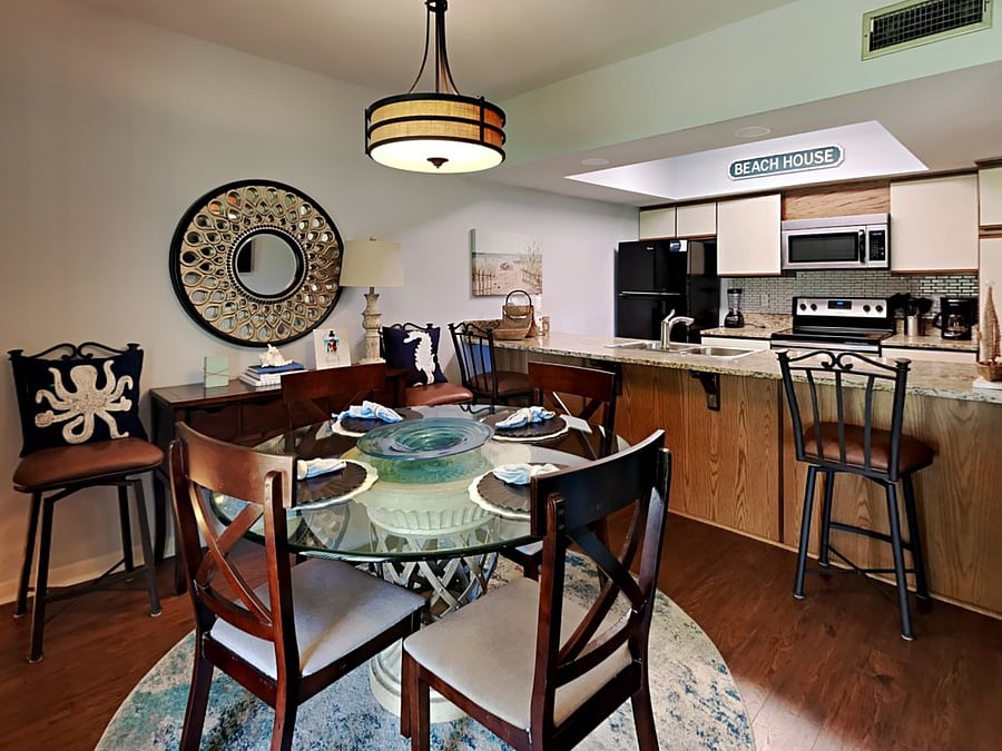 Dining area on first floor has table and bar seating of 4 each.