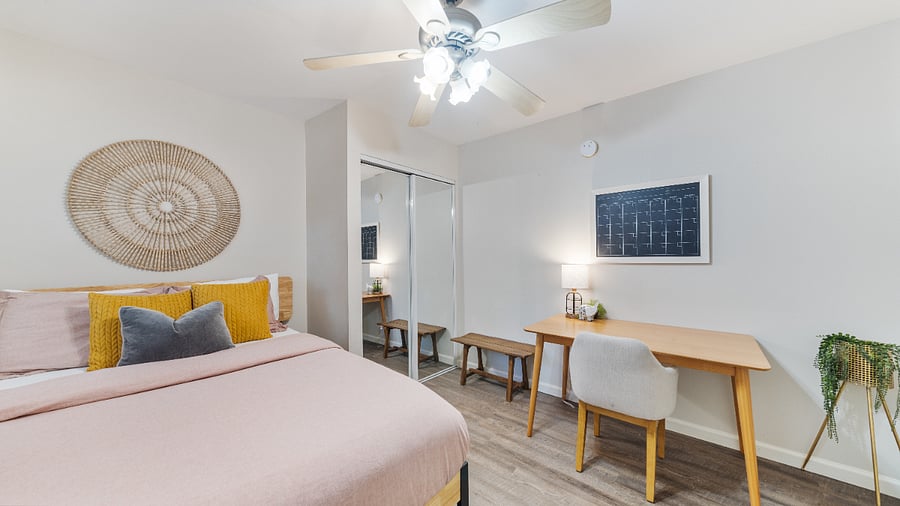 Queen bedroom with TV and desk 