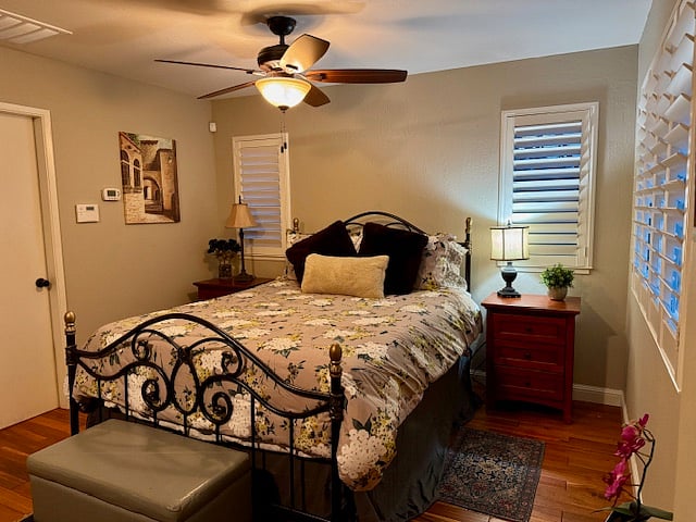 New queen size Beauty Rest mattress, platform bed with large drawers, 2 full size double drawer nightstands, full size ceiling fan above bed, plantation blinds.