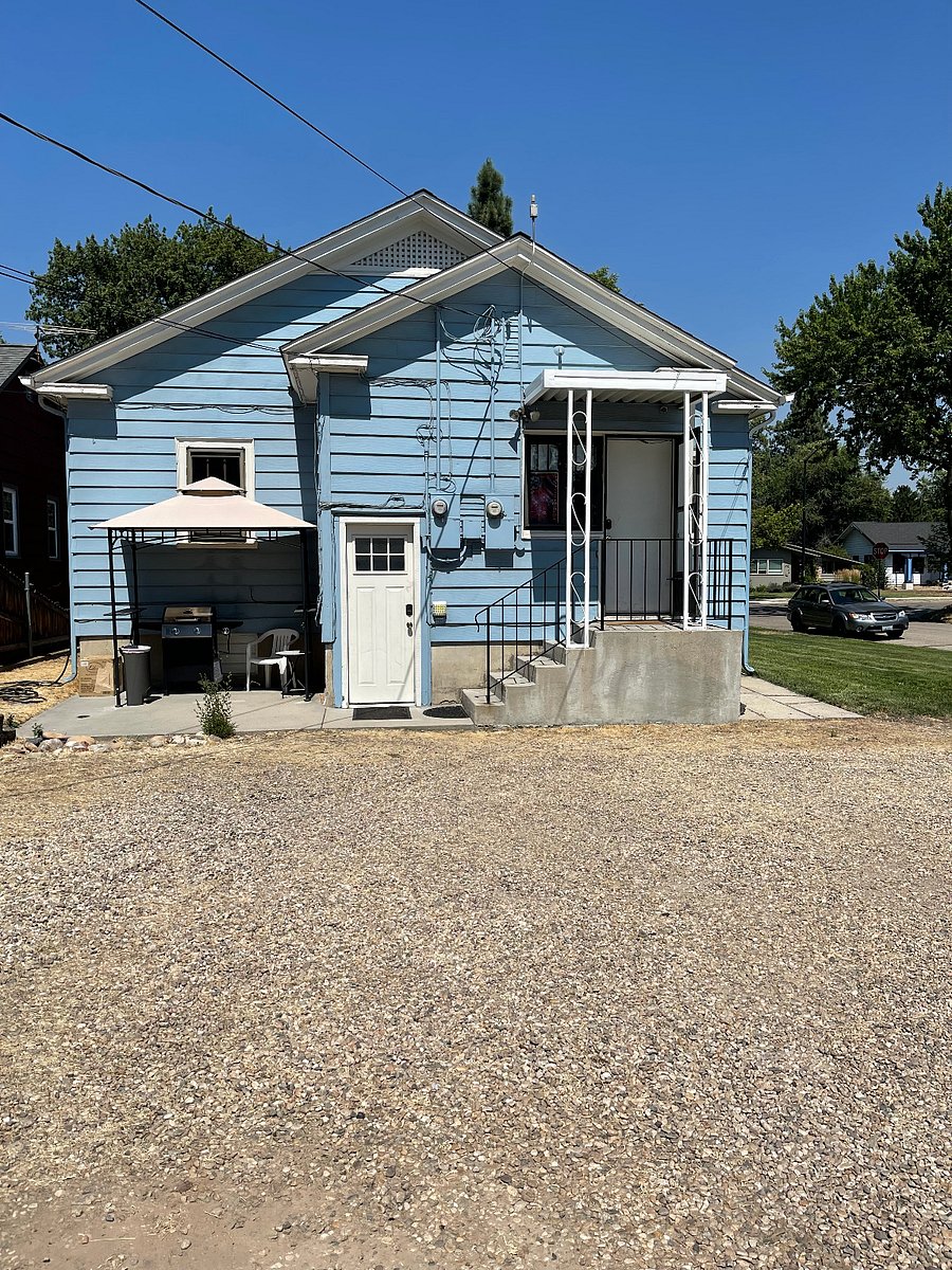 Rear of the Property/Parking area. The white door in the middle of the photo is the back entrance to the downstairs unit.