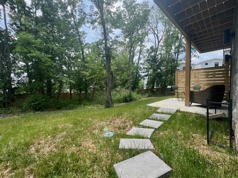 This private backyard area is fenced in and features lush greenery.