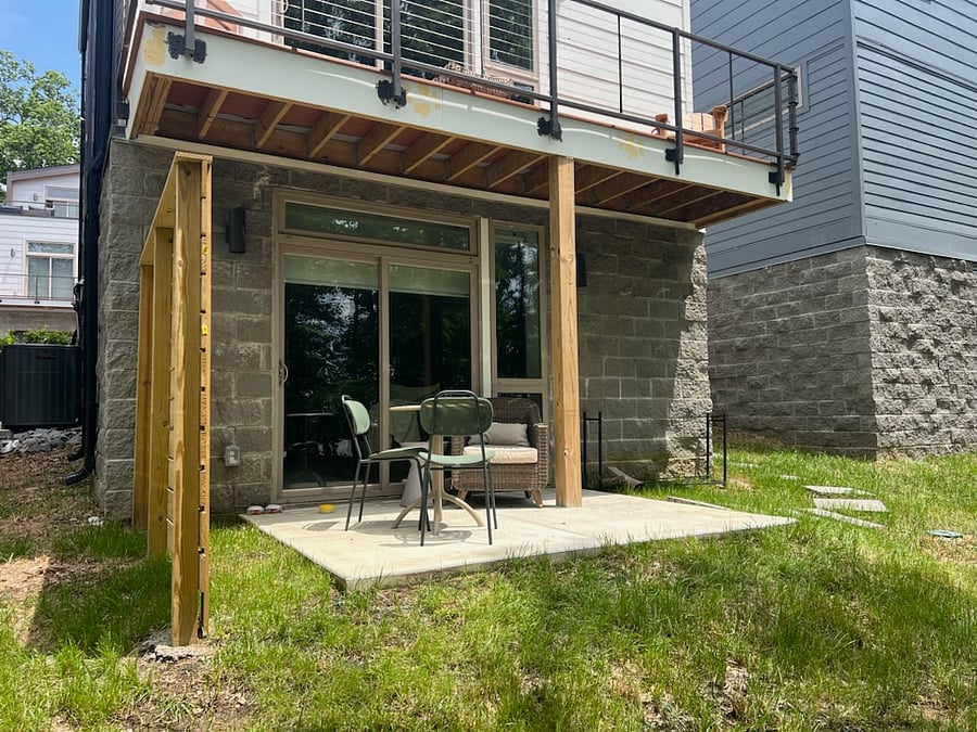 Exterior patio features a comfy outdoor reading chair as well as a 2-person bistro table.