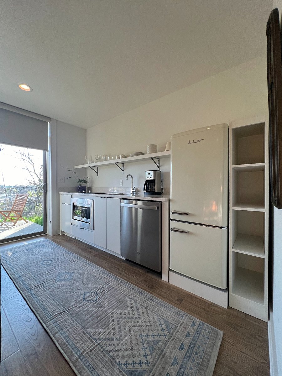 Small but mighty, this kitchen has everything you need including a 2-unit stovetop burner, duel microwave/oven, dishwasher, full-sized vintage inspired fridge and pantry storage.