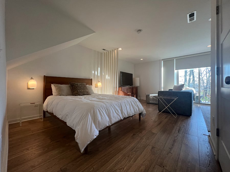 This cozy apartment is divided into two separate areas - bedroom and living room - while maintaining an open concept.