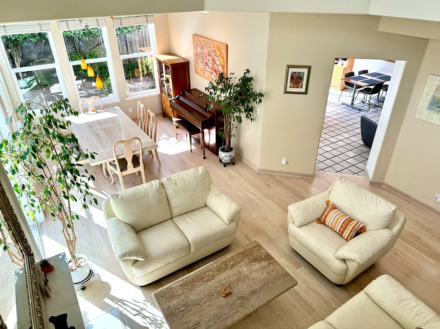 Birds-eye view of the common areas of the house, including dining room for 6, living room, entry to kitchen with dining for 4.