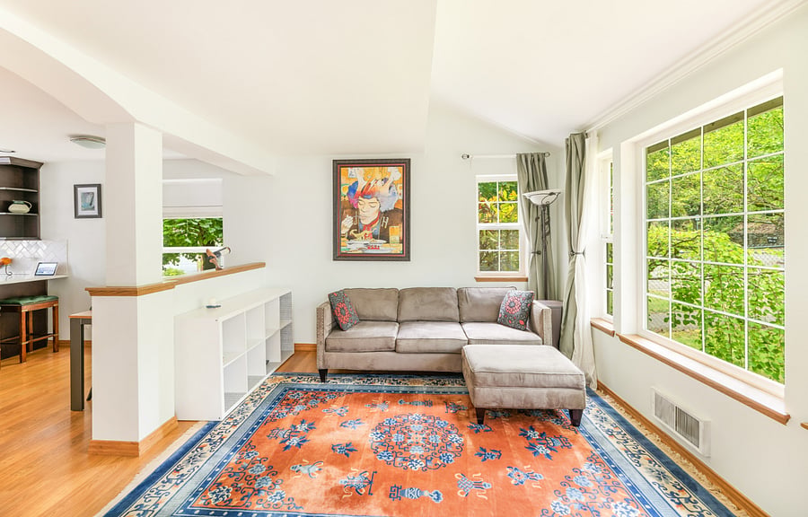 beautiful wool rug, professionally cleaned, large windows and raised ceiling in living room