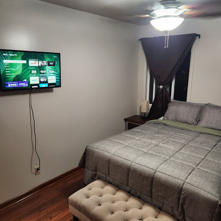 Master Bedroom - Queen Size Bed, Roku Smart TV and Bedside table.