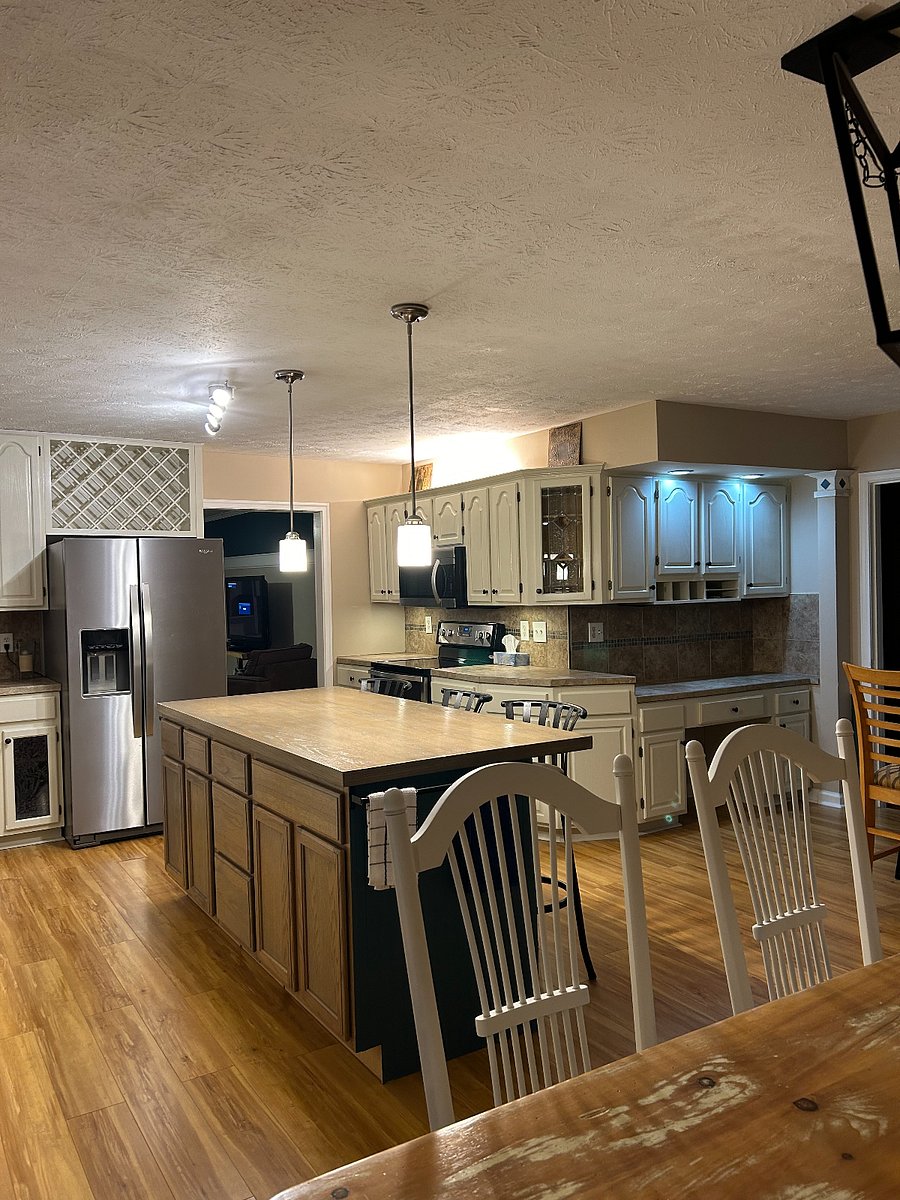 Shared kitchen with large island and farm table
