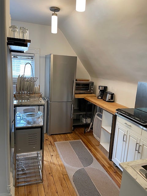 Fullsize fridge, convection oven/air fryer, coffee maker, toaster, microwave, tea kettle.