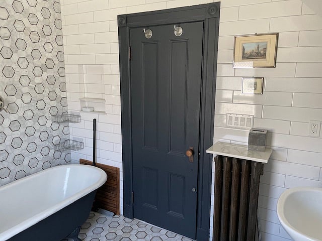 Open shower includes claw foot tub