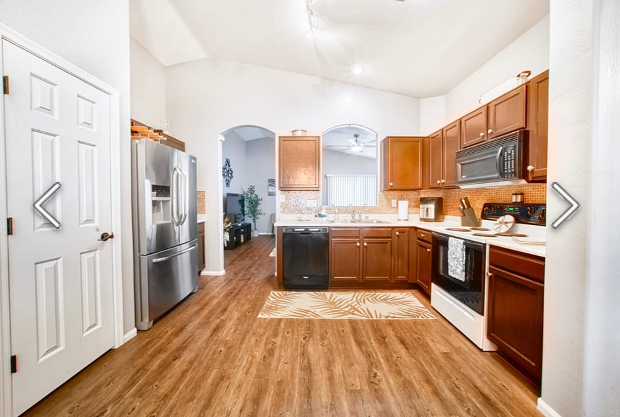 Kitchen fully stalked with dishes, spices, air fryer, waffled maker for kids, and lots more