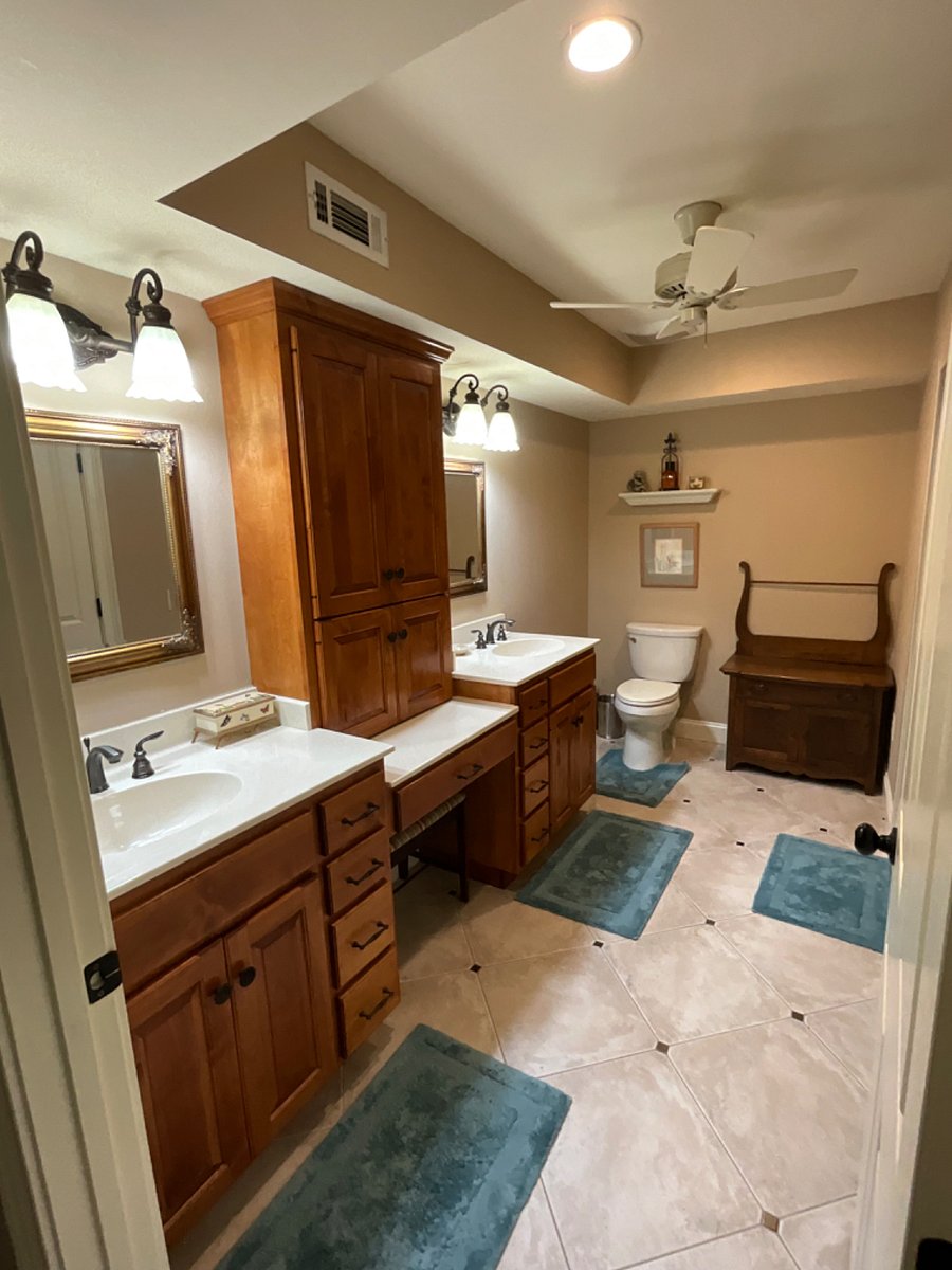 Bathroom with double sinks, vanity and steam shower.