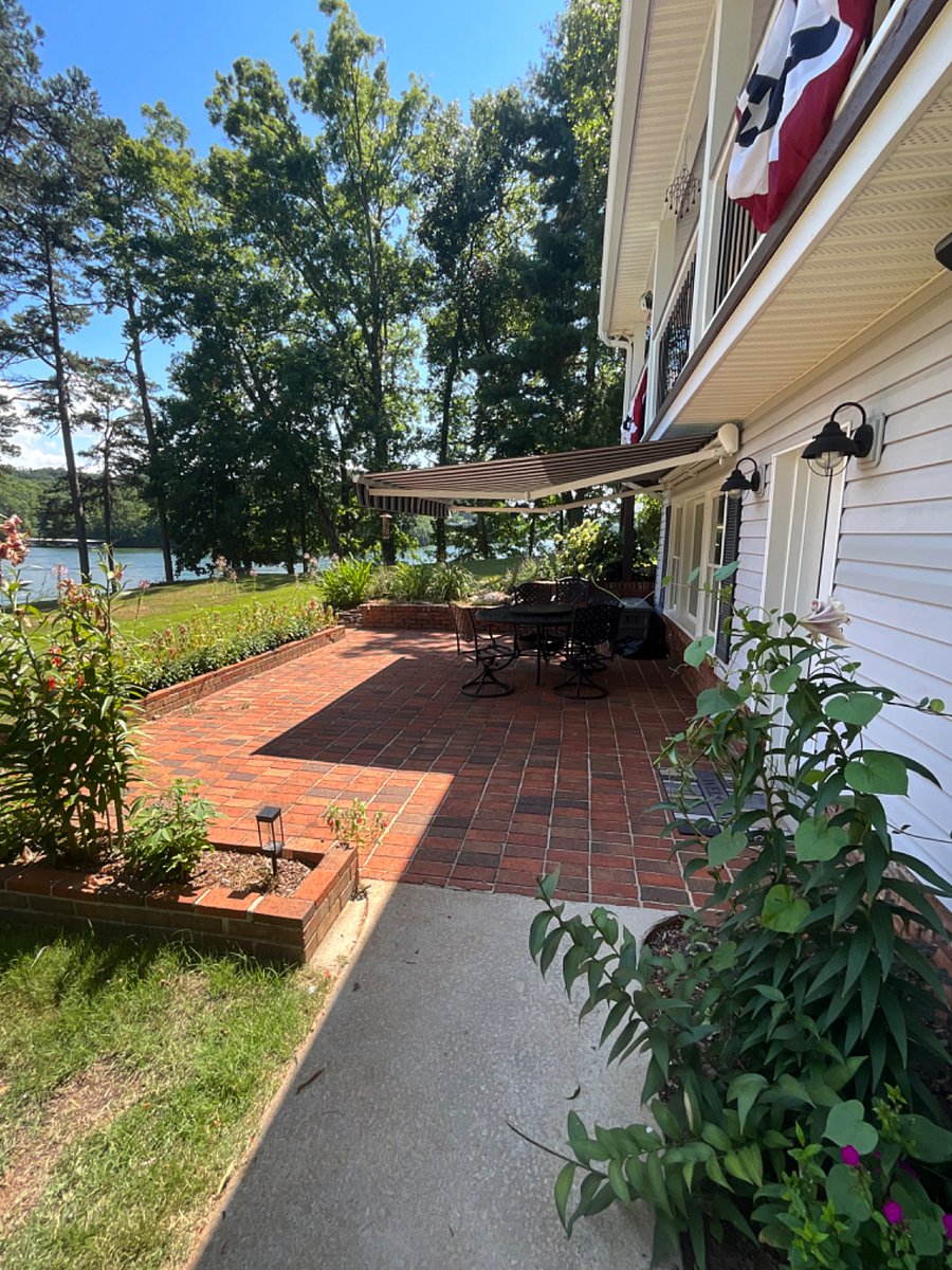 Brick patio with retractable awning.