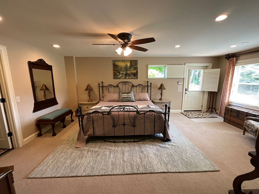 King sized bed. Lake view and door to side patio area.
