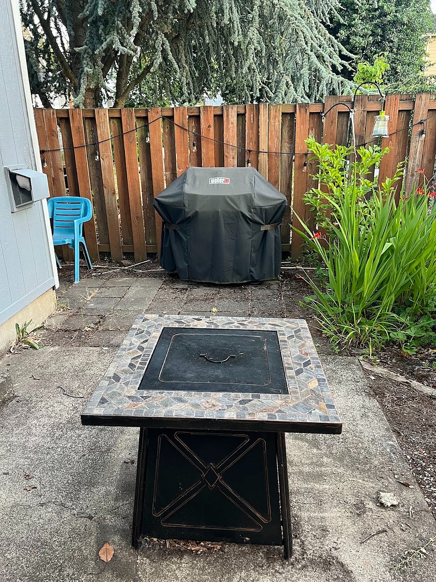 Outdoor fire pit, propane grill, available garden box just behind and to the right of the flowers