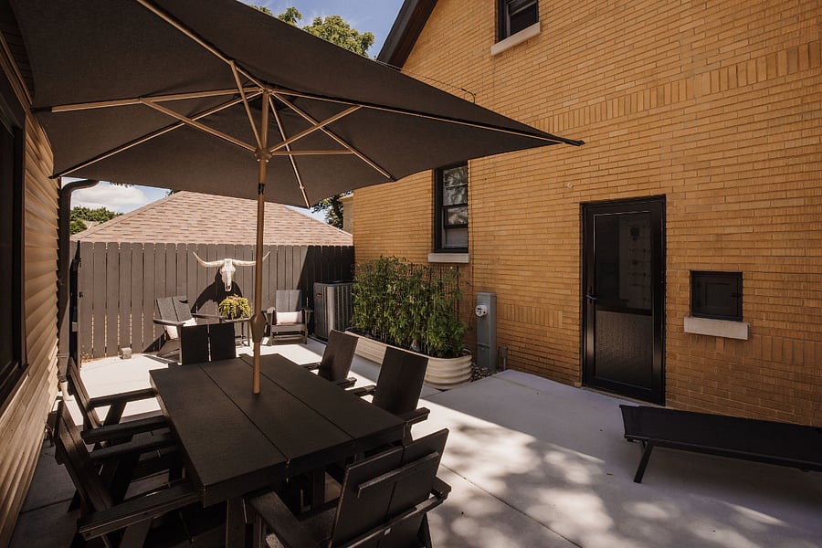 Lovely outdoor dining table and chaise lounge for your use! The door is your entrance to the stairway down to the apartment.