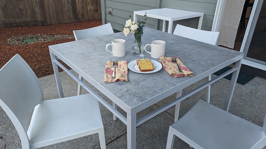 Covered eating area with table and chairs