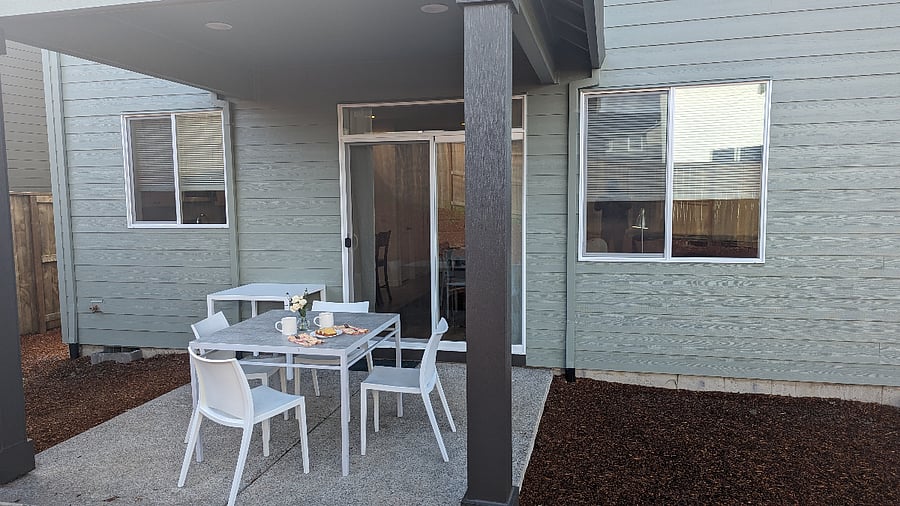 Covered eating area with table and chairs