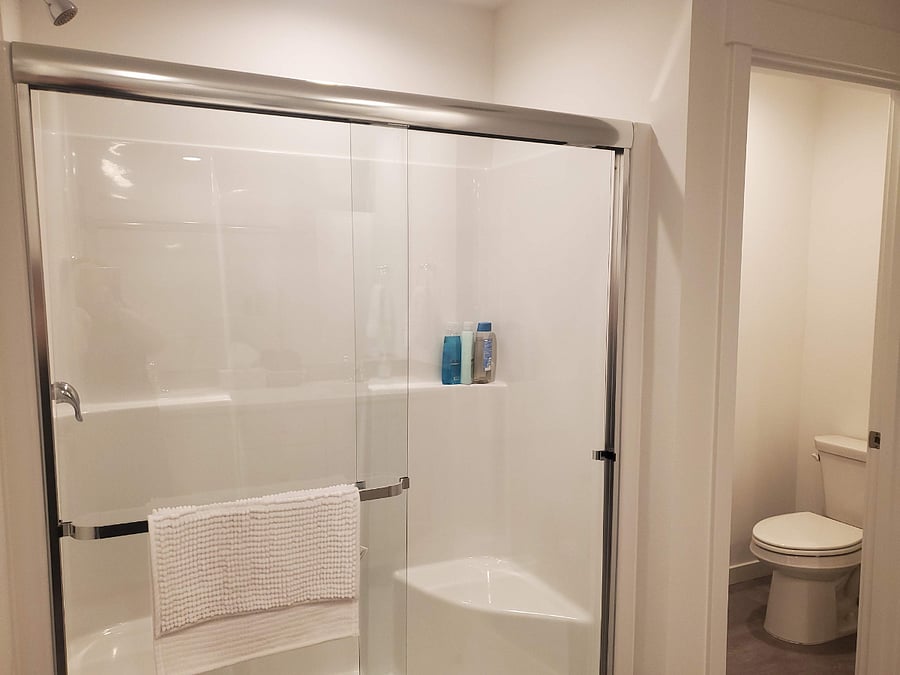 En suite bathroom with walk in closet accompanies the primary bedroom