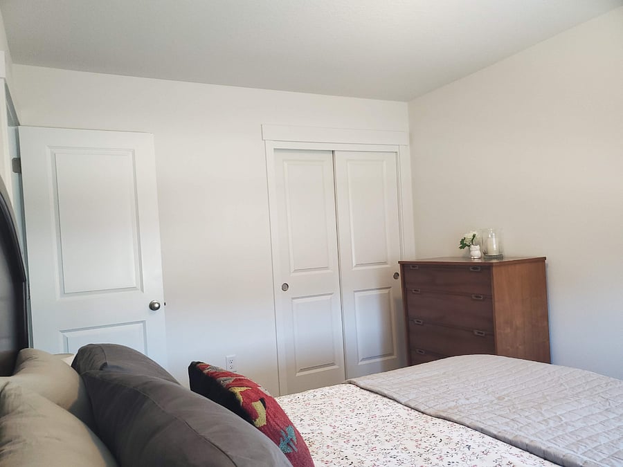 Dresser and full closet in second bedroom with queen bed