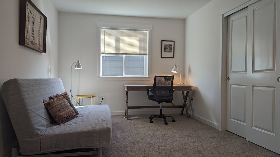 Separate office area with desk, desk chair and futon.