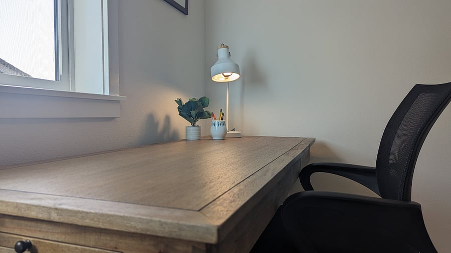 Separate office area with desk, desk chair and futon.