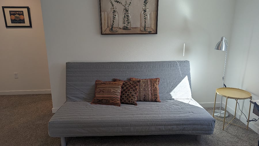 Separate office area with desk, desk chair and futon.