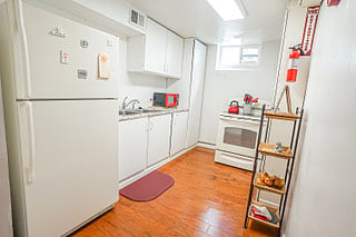 Kitchenette with Electric Stove, Refrigerator and Microwave. 

