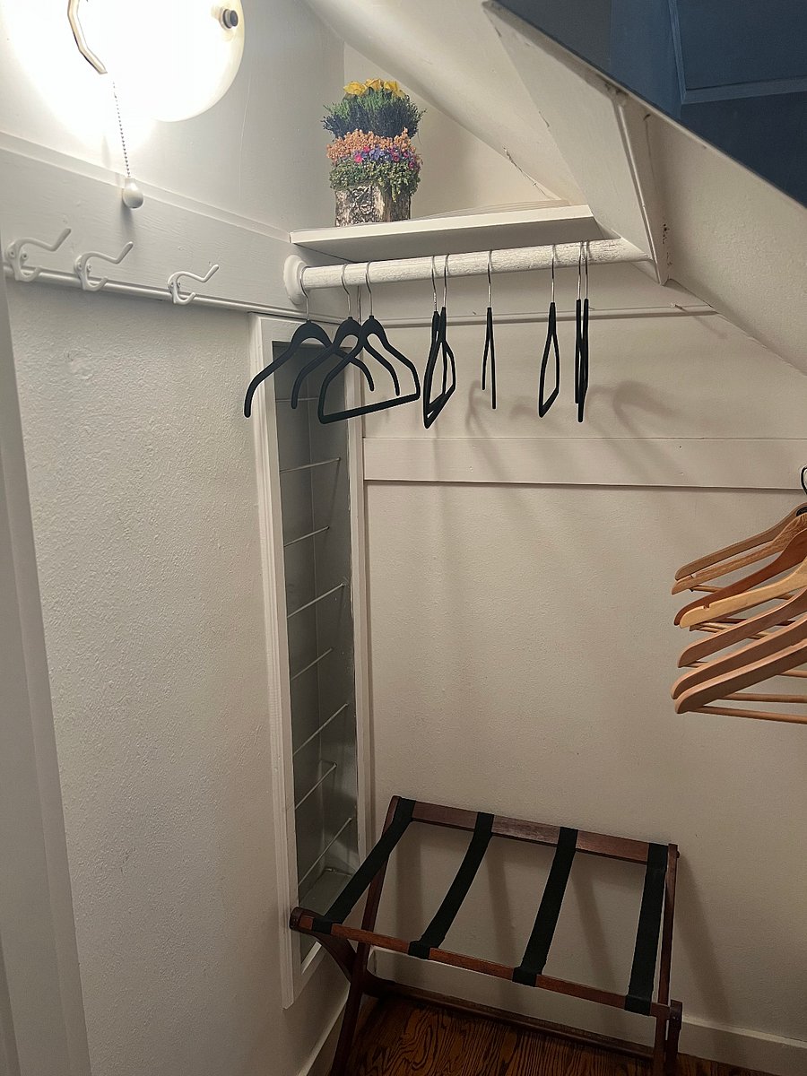 Dedicated closet with hanging space, shelving, luggage rack, and storage.