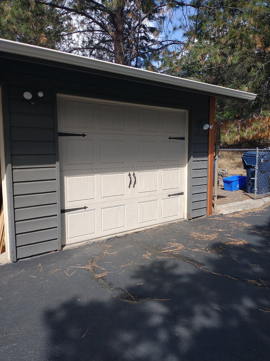 Trash and recycling bins, next to the garage.