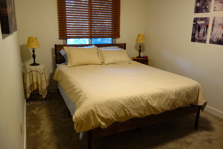 Master Bedroom with cream stiped comforter and matching duvet covers.  Extra pillows.