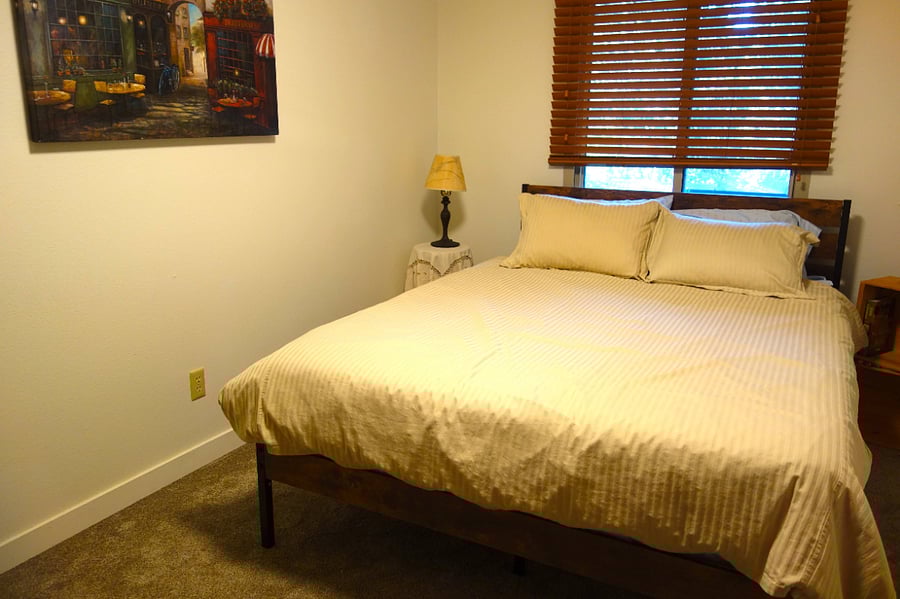 Master Bedroom - lamps and bedside tables.   Nice art.