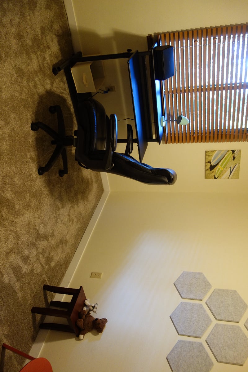 Office with standing/sitting desk and guest chair.