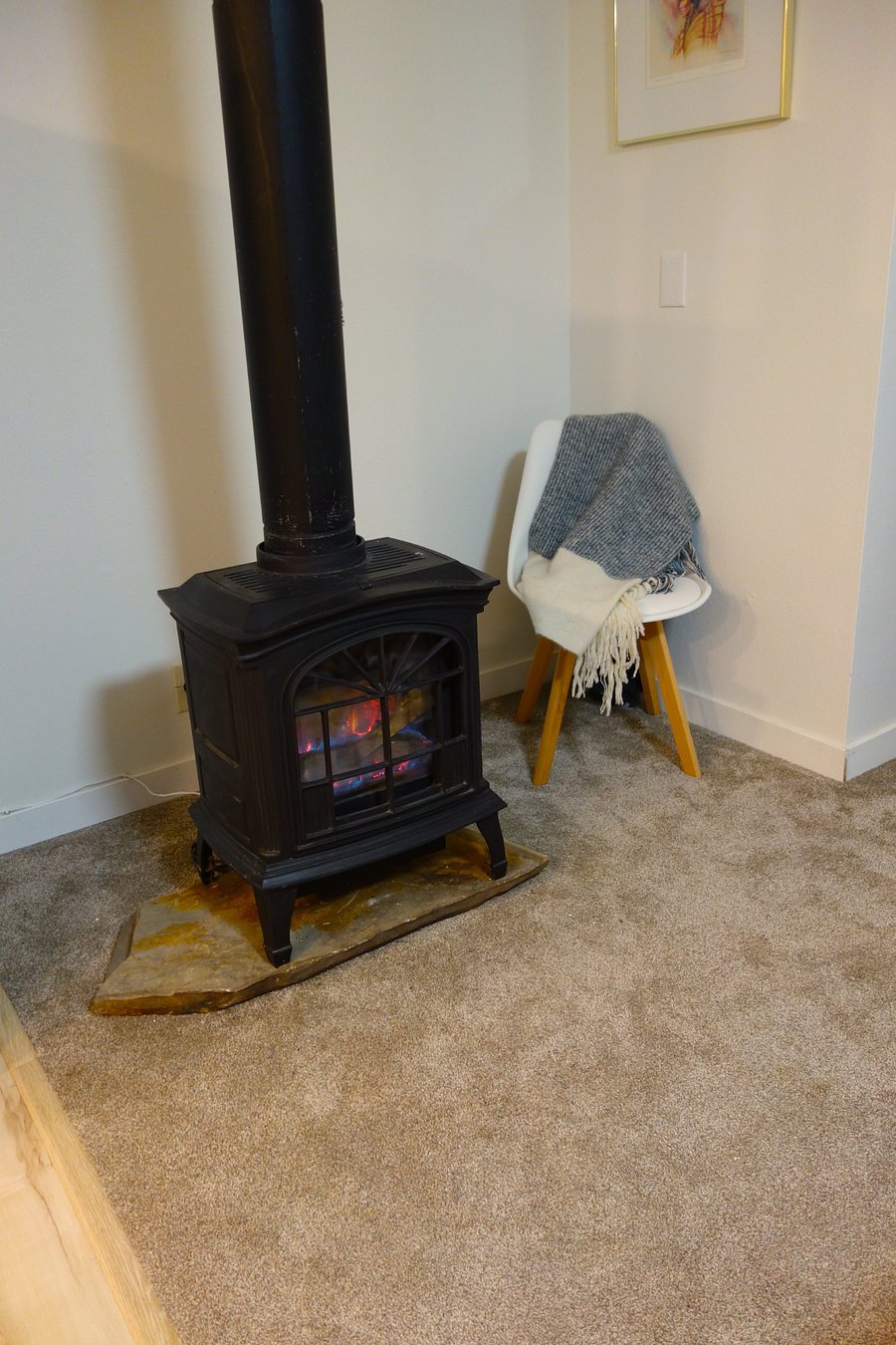 This gas stove fireplace replaces the electronic fireplace seen in the living room/den area.   