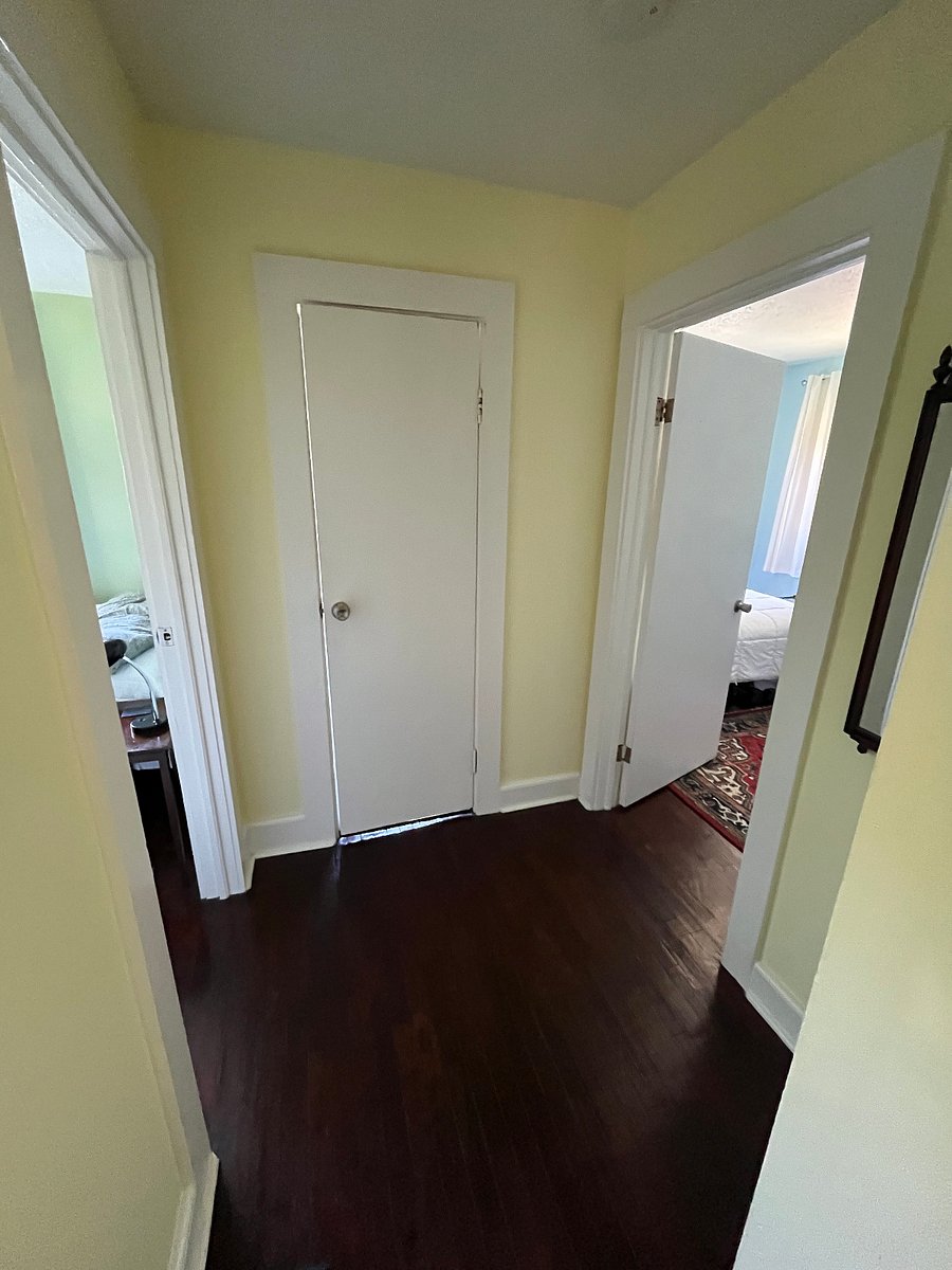 Hallway with office/bedroom on left, master bedroom on right. and bathroom in center.