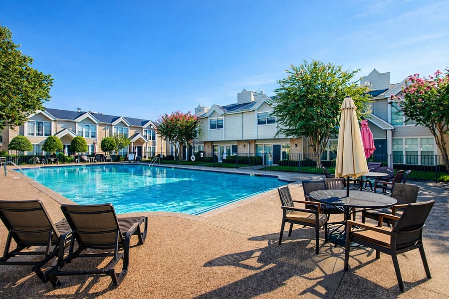 Beautifully maintained pool area with outdoor seating and landscaped surroundings.