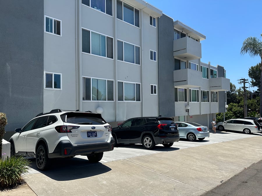One dedicated, assigned off-street parking space for you (far left, white car)
