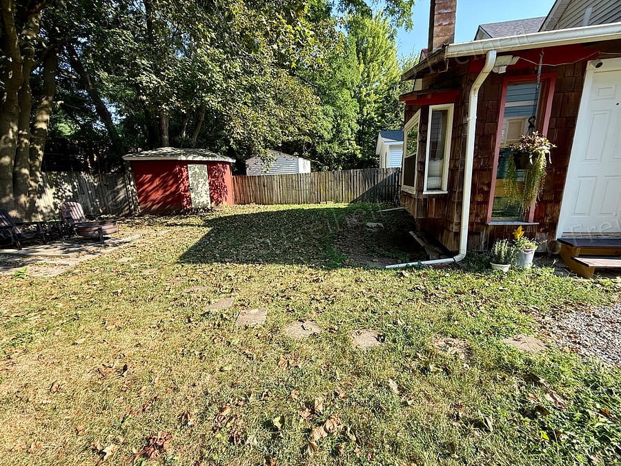 Rest of backyard, has firepit/grill and seating area.