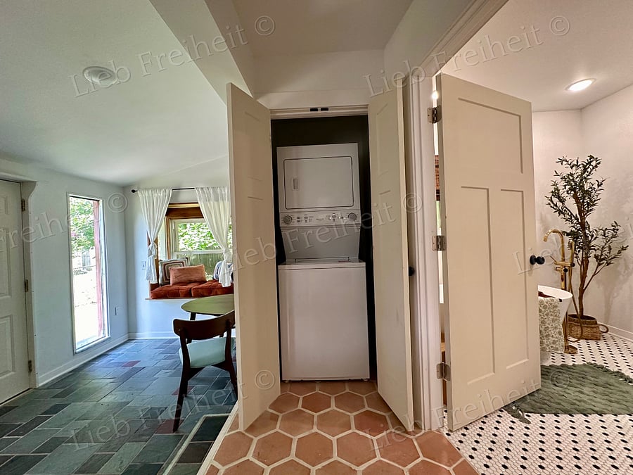 Stackable washer/dryer between main floor restroom and office/flex room.
