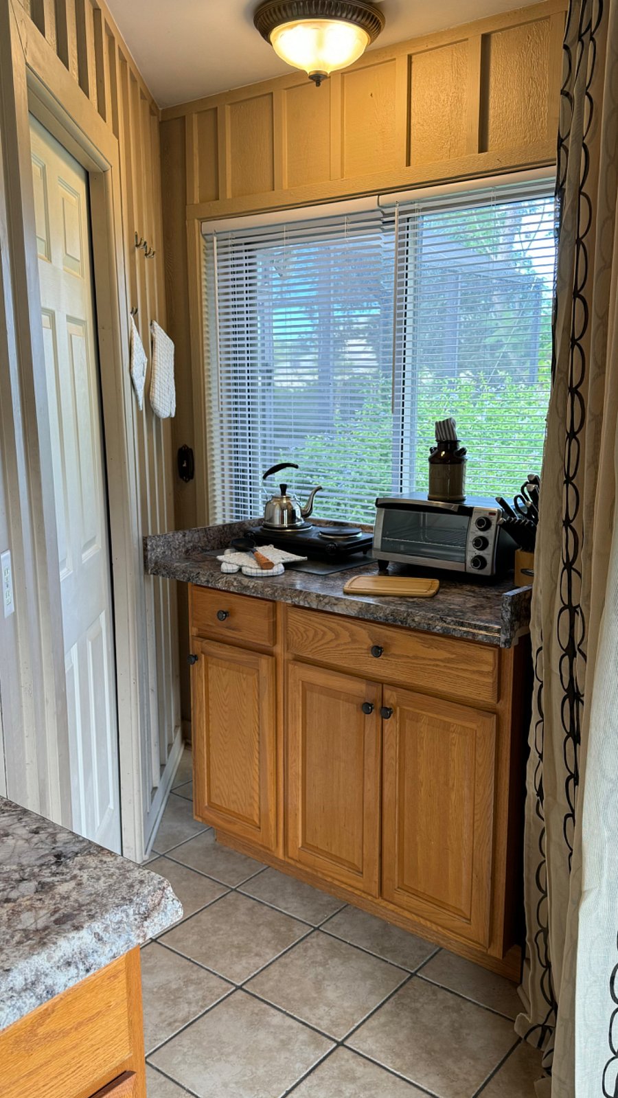 Tea pot, toaster oven, knives and views.