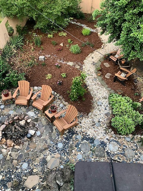 The backyard is landscaped and has a fire pit and many nice places to relax.